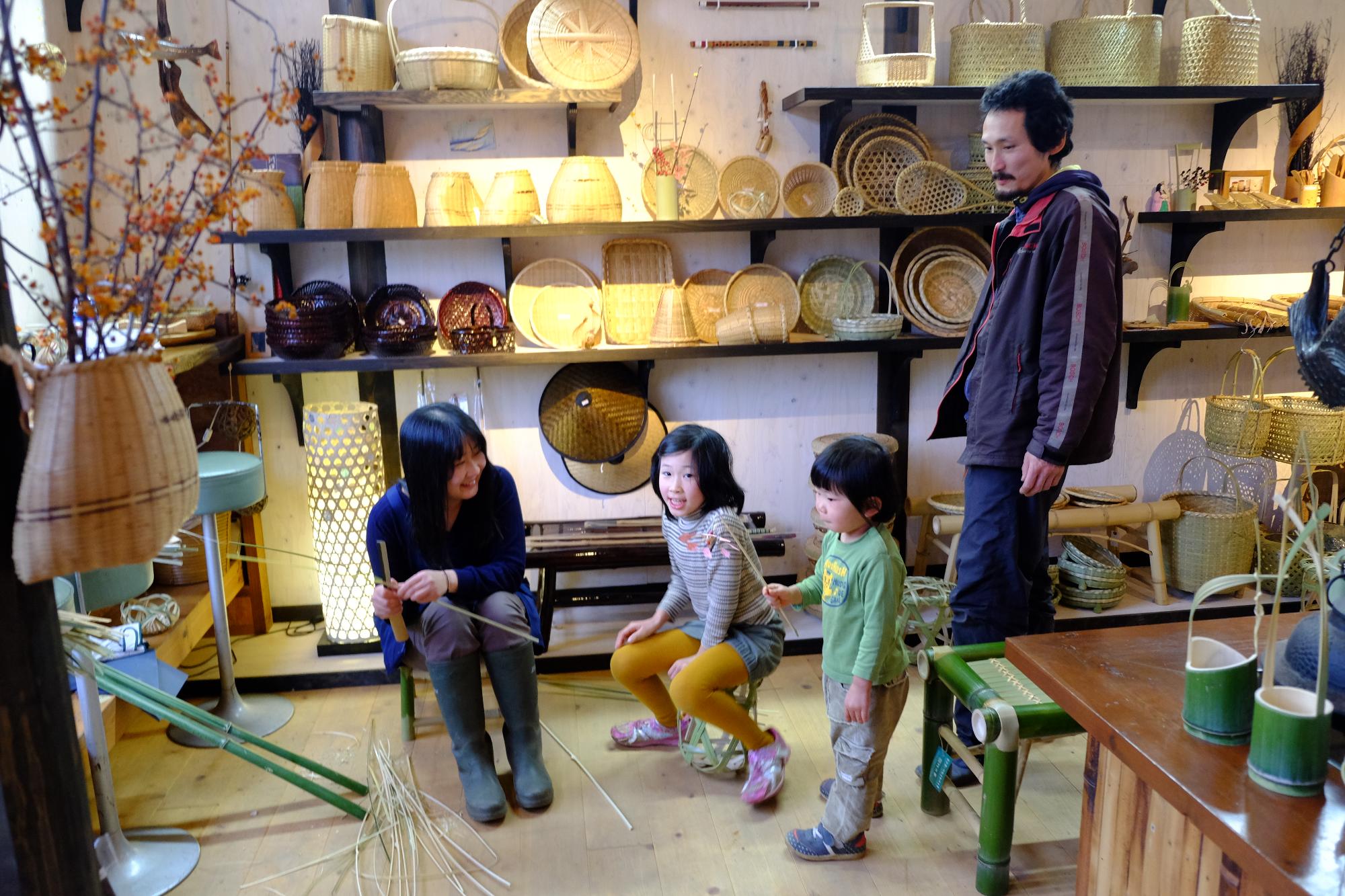 竹細工をしている沼澤さん家族の写真