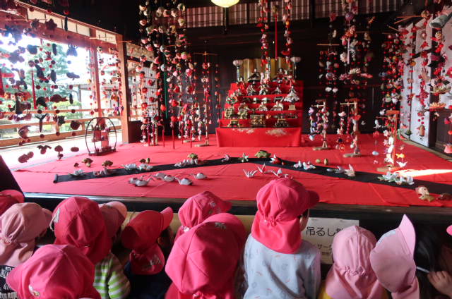 1・2歳児が、古民家のおひなさまを見ている写真