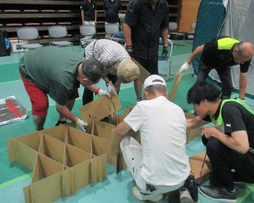 避難所開設研修・訓練（参加者がダンボールベッドを組み立てている様子）